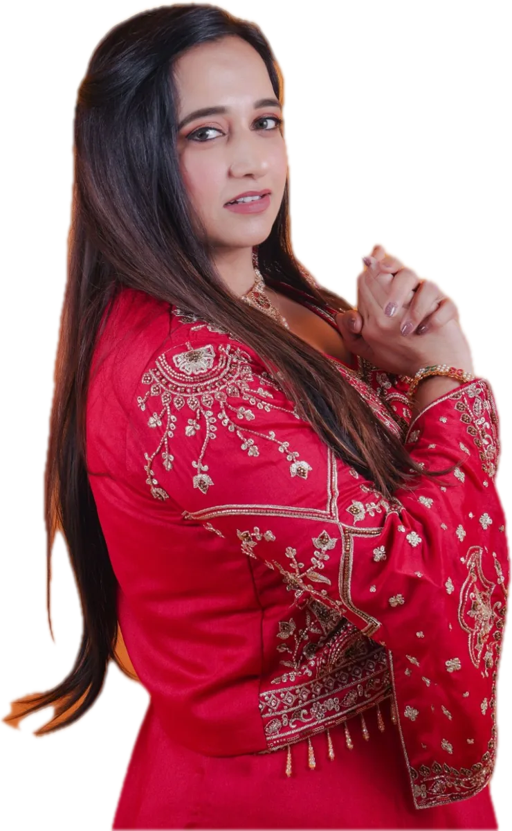 Diimple Pancholi in a red embroidered outfit, looking over her shoulder